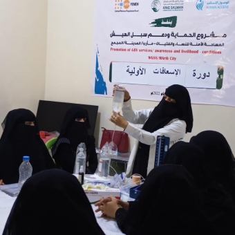 In the presence of a number of women and girls, First-aid training