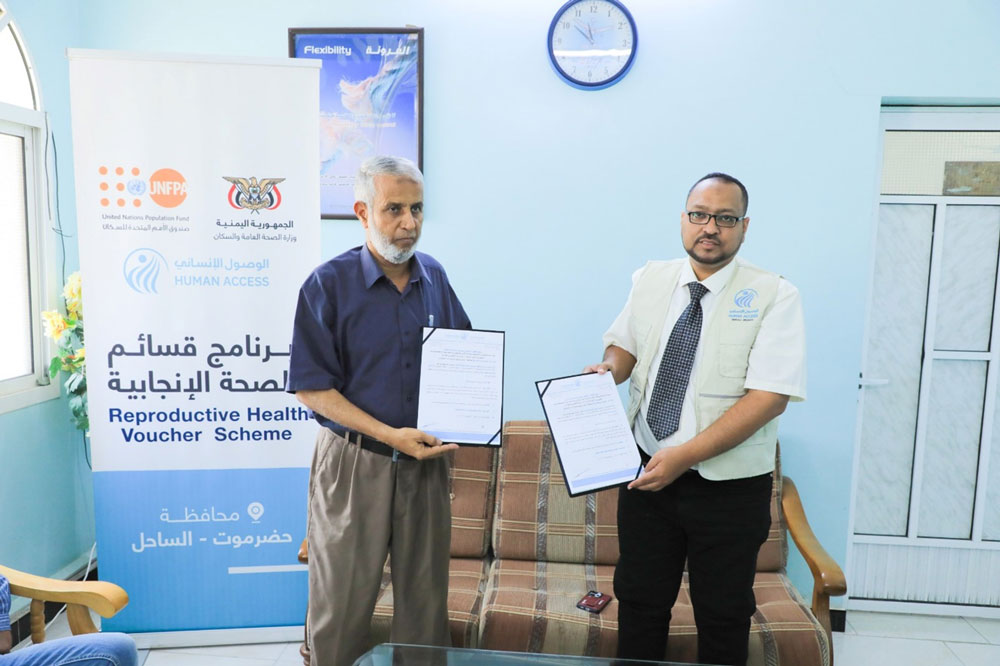 Signing an agreement to implement a reproductive health voucher program