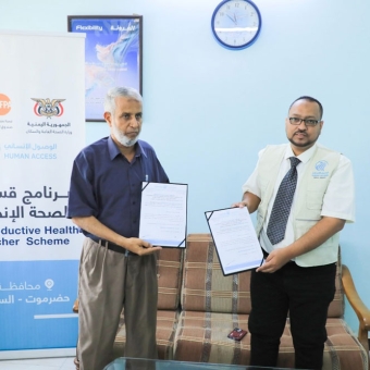 Signing an agreement to implement a reproductive health voucher program